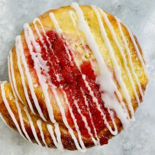 a raspberry donut with white icing