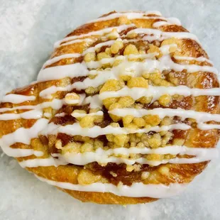 a pastry with icing and nuts