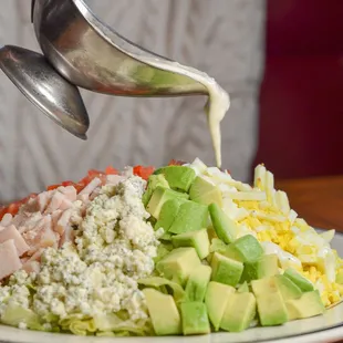 This Cobb&apos;s got it all! 
Loaded with diced avocado, crunchy bacon, bleu cheese, turkey, green onion, tomato, &amp; hard-boiled egg!