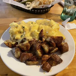 Eggs Benedict with Hollandaise sauce and potatoes!