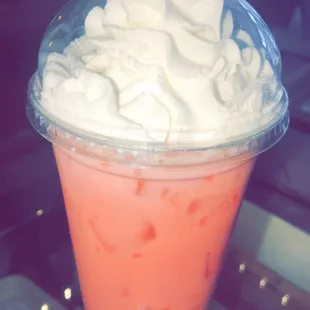 a drink with whipped cream in a plastic cup