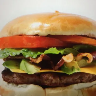 a cheeseburger with lettuce and tomato