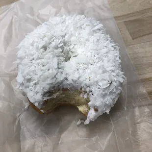 a half eaten coconut donut