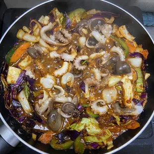 a pan of food cooking on a stove