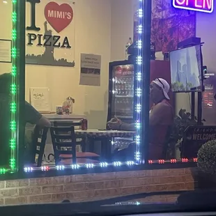 Owner chatting with customers like a true NY pizza place