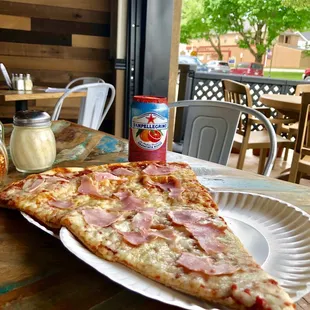 a slice of pizza on a paper plate