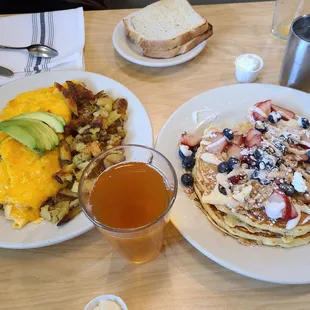Shrimp omelet with baked potatos. Blubbery pancakes with strawberry.  And apple juice