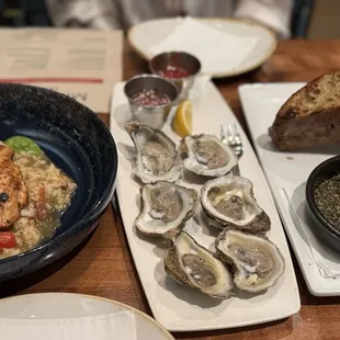 Smoked salmon with risotto, oysters and focaccia bread served with provencal herbs and olive oil.