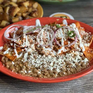 Chilaquiles w side of beans. Straight Fire.. I liked the beans better than the potatoes.
