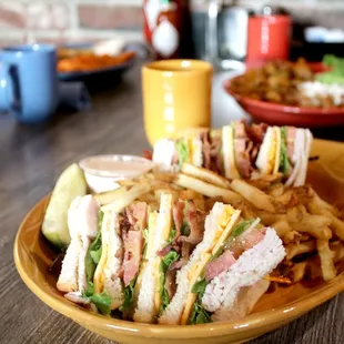 a plate of sandwiches and french fries