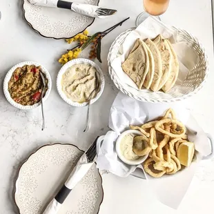 Top left: Eggplant salad - $6 Center: Hummus (original) - $6 Top right: Pita bread - included Bottom right: Deep fried calamari - $15