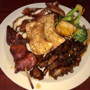 a plate of food with meat and vegetables
