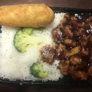 Orange chicken combo dinner with white rice and egg roll. Very spicy!