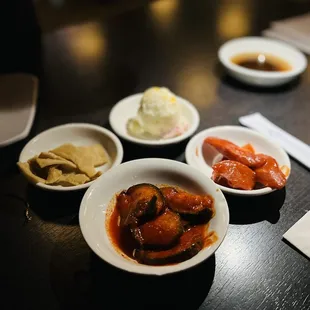 three bowls of food on a table