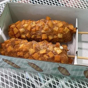 Korean corn dog with half mozzarella cheese and half hotdog, coated with potatoes.