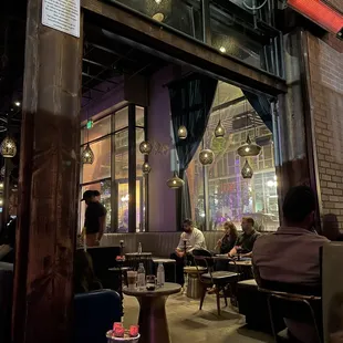 people sitting at tables in a restaurant