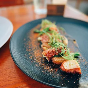 Grilled octopus with roasted fingerling potatoes, charred scallion &amp; spicy togarashi dust
