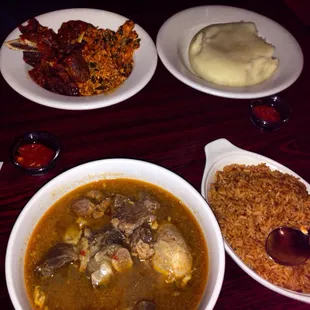 Back row: egusi and fufu; front row: pepper soup and jollof rice