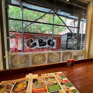 a restaurant window with menus on the table