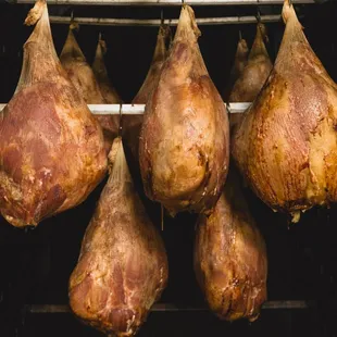 a bunch of meat hanging from a rack