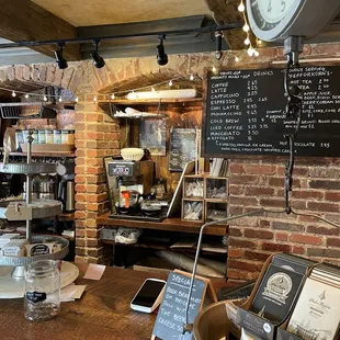 a coffee shop with a brick wall