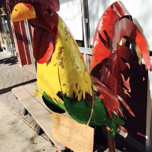 a rooster on a bench