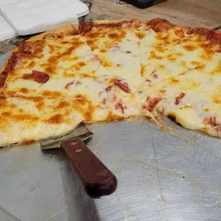 a half eaten pizza on a pizza pan