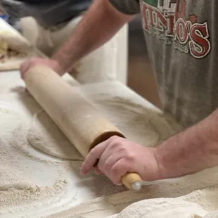 a man rolling dough