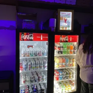 a woman standing in front of a cooler