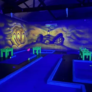 a mini golf course with neon lights