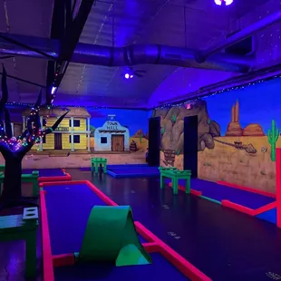 a mini golf course with neon lights