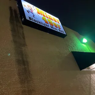 a neon sign on the side of a building