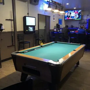 a pool table in the foreground