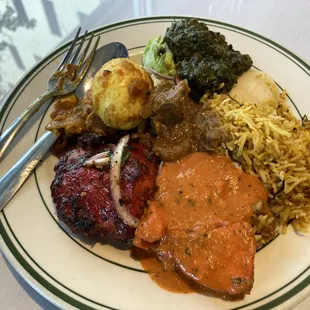 a plate of food with meat, rice, and vegetables