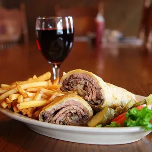 a plate of food and a glass of wine