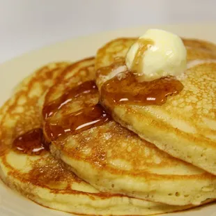 a stack of pancakes with butter and syrup