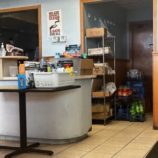 Lots of supplies being stored in the dining room and random things for sale - like a grocery/pharmacy clearance section.