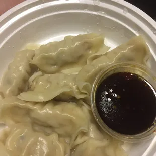 a plate of dumplings and sauce
