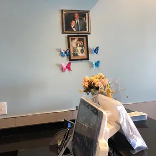 a laptop on a table with a bouquet of flowers