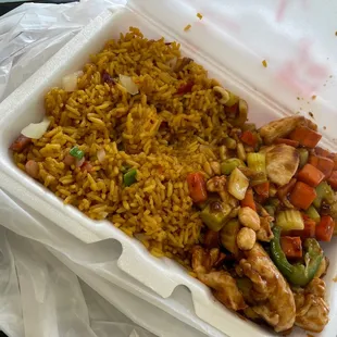 a take out container of rice and vegetables