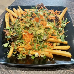 &quot;Loaded sloopy fries&quot; with pulled pork, jack cheese, and ginger dressing.