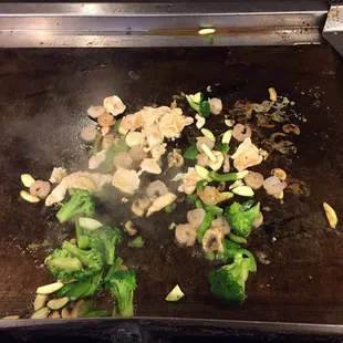 broccoli and mushrooms being cooked