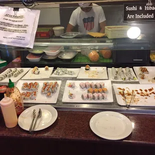 a sushi bar with plates of sushi