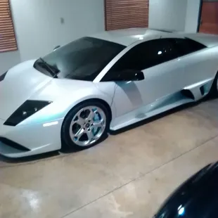 a white sports car in a garage