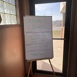 a welcome sign in front of a window