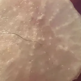 A pubic hair on daikon radish slice