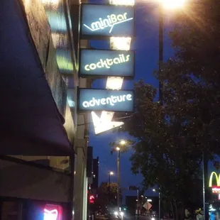 neon signs on the side of a building
