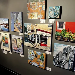a variety of paintings on a wall