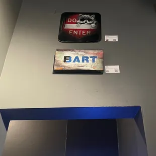 a man standing in front of a bar sign