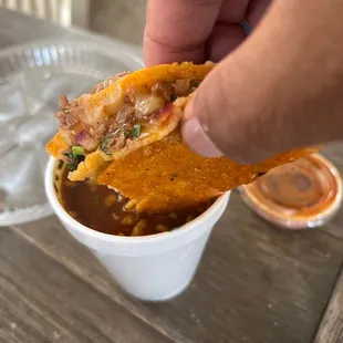 a hand holding a piece of food